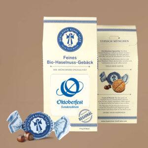 Große cremefarbene Packung mit blauem Text und Inlay Logo Oktoberfest in blau. Sechs einzeln verpackte Münchner Kindl-Taler