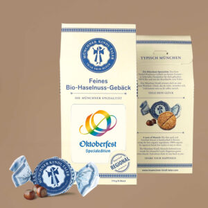 Cremefarbener Karton mit Sichtfeld mit dem Oktoberfest Logo in Regenbogen Farben. Secs einzeln verpackte Münchner Kindl-Taler in blau. 114g
